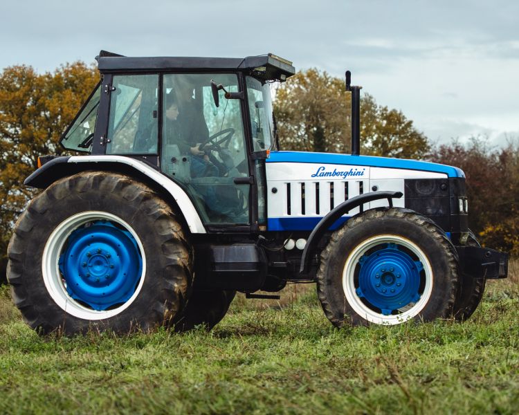 a lamborghini tractor being driven in a field on a tractor driving experience