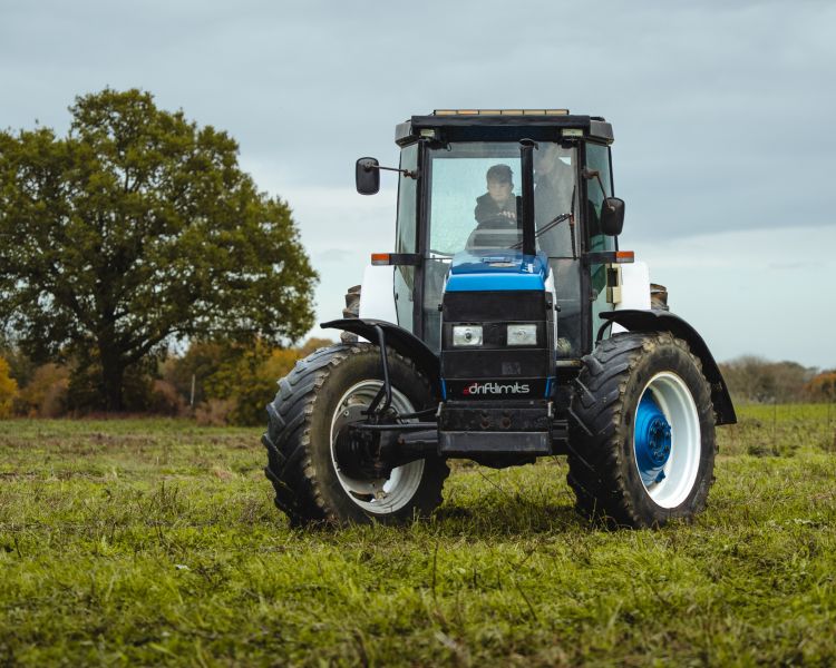 a lamborghini tractor being driven in a field on a tractor driving experience