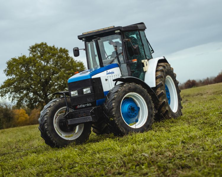 a lamborghini tractor being driven in a field on a tractor driving experience