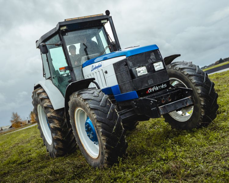a lamborghini tractor being driven in a field on a tractor driving experience