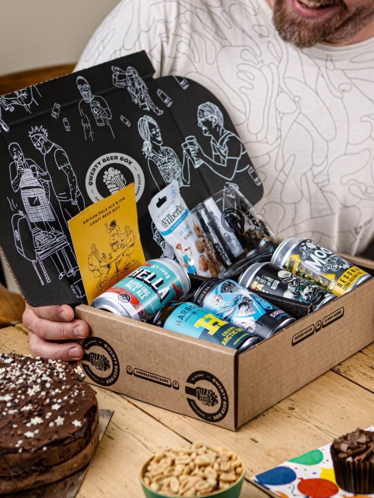 Man opening qwerty gift box of five cans of pale ale with snacks on birthday