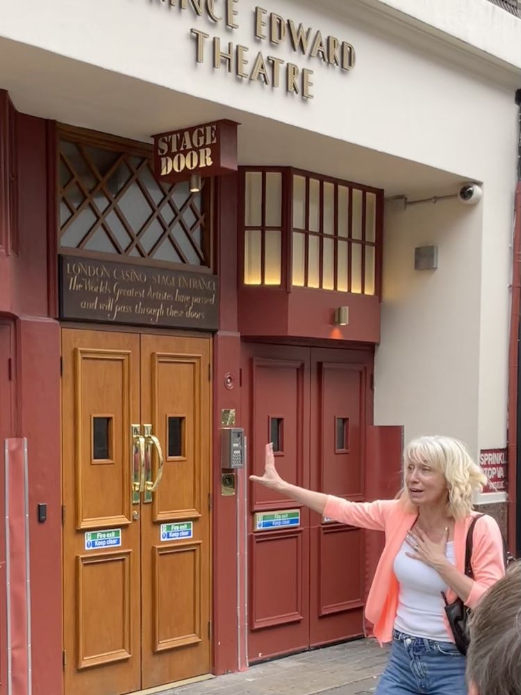 tour group outside the prince edward theatre in london