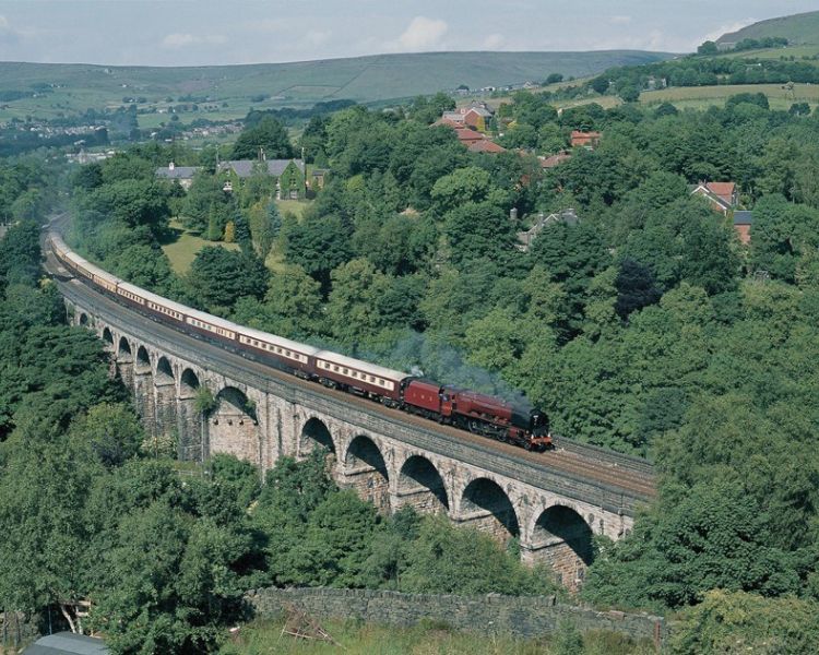 northern belle steam train travelling over a viaduct