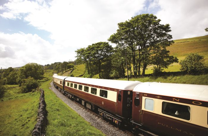 northern belle train travelling through countryside