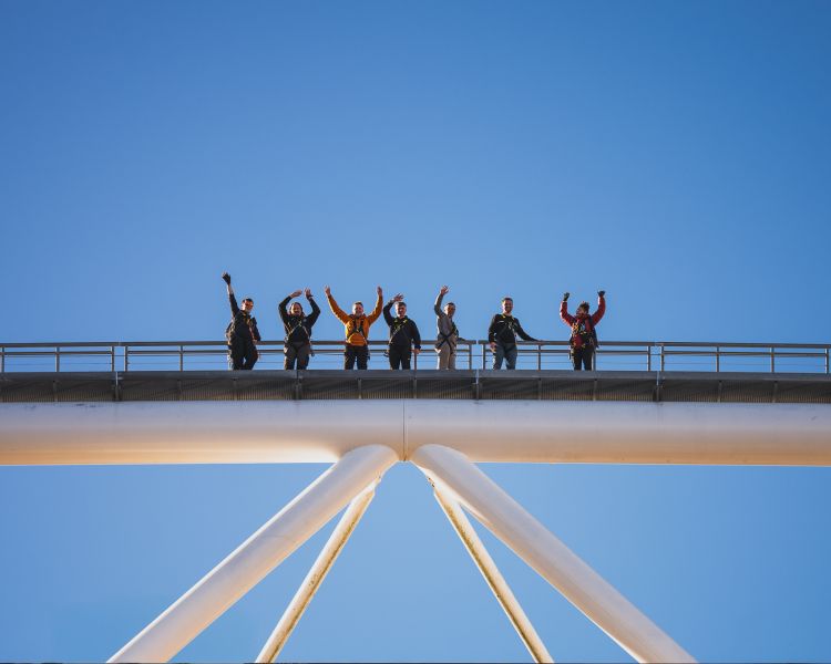 People waving on top of stadium at zip world cardiff