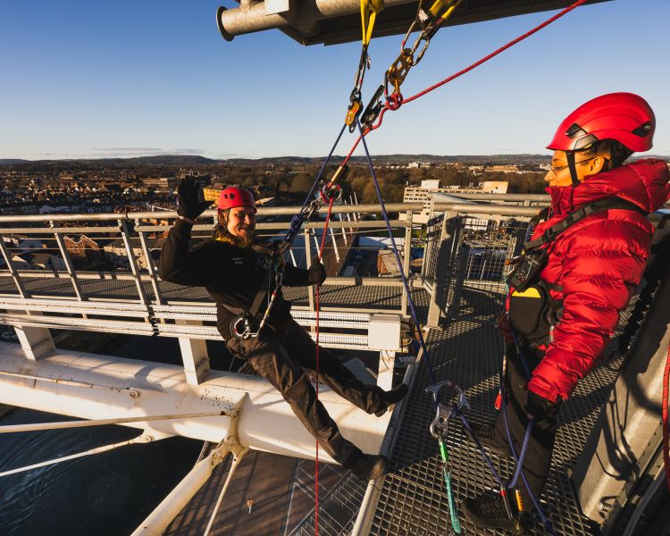 Man about to abseil down cardiff stadium at zip world