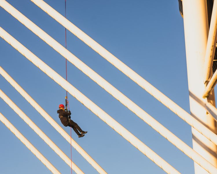 person abseiling down cardiff stadium at zip world