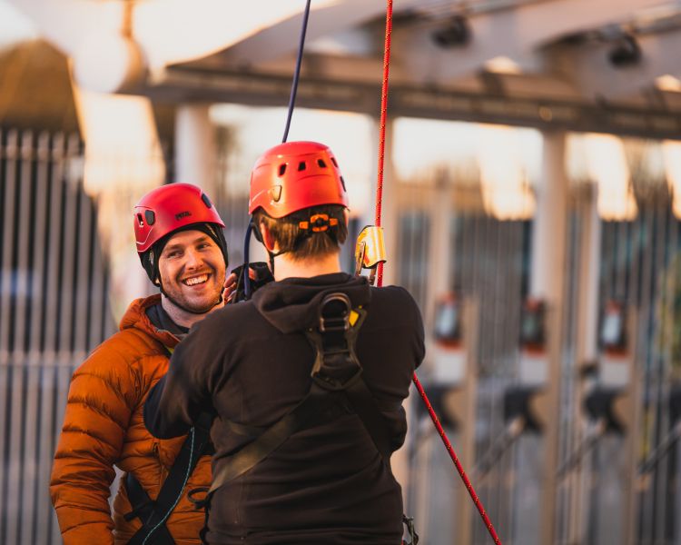 man on ground after abseiling down cardiff stadium at zip world