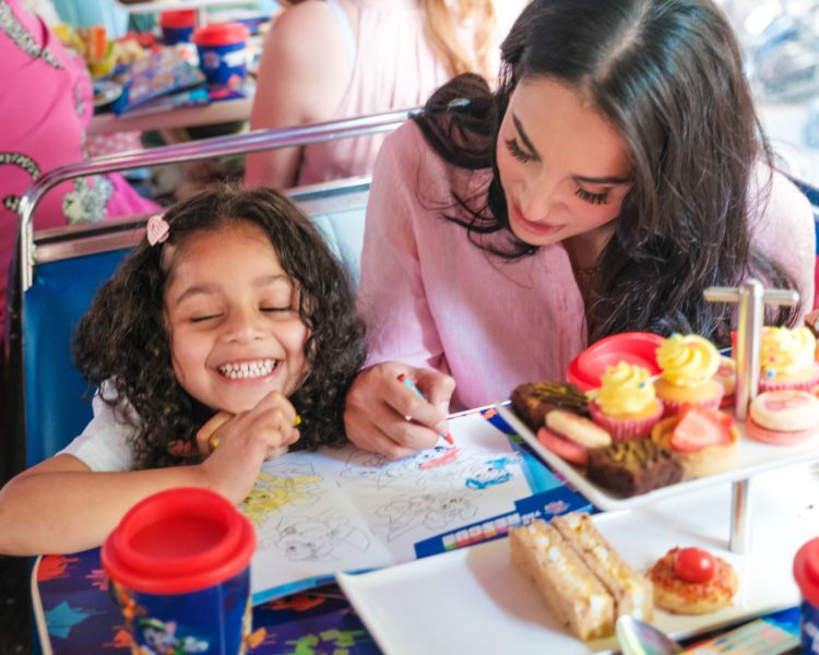 Mum and daughter colouring in on paw patrol afternoon tea bus tour london