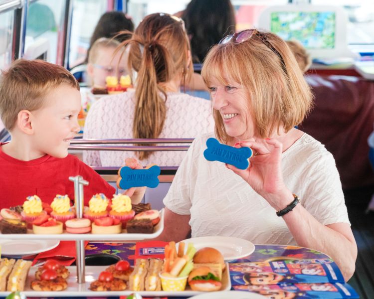 Woman and boy on paw patrol afternoon tea bus tour london