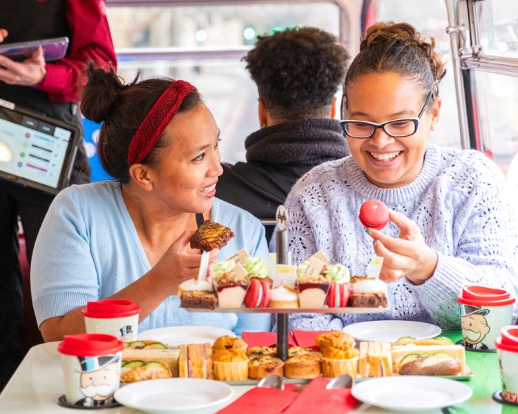 ladies eating an afternoon tea on a monopoly bus tour in london