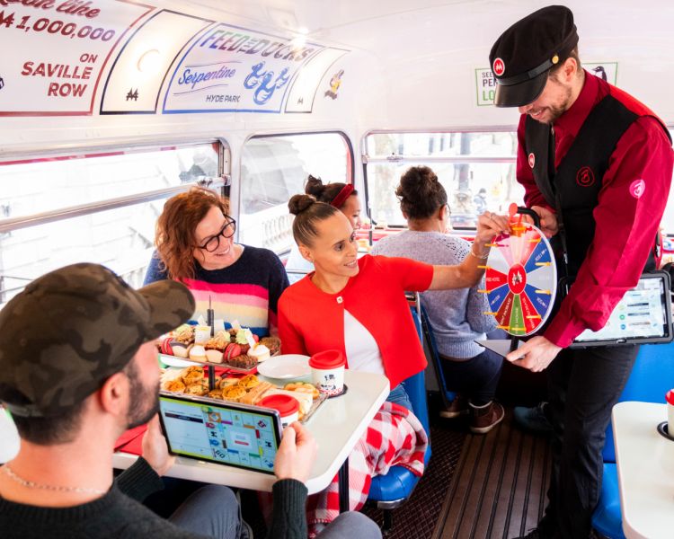 people playing games on the monopoly afternoon tea bus tour in london