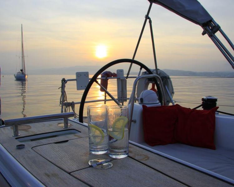 gin and tonic at sunset on yacht