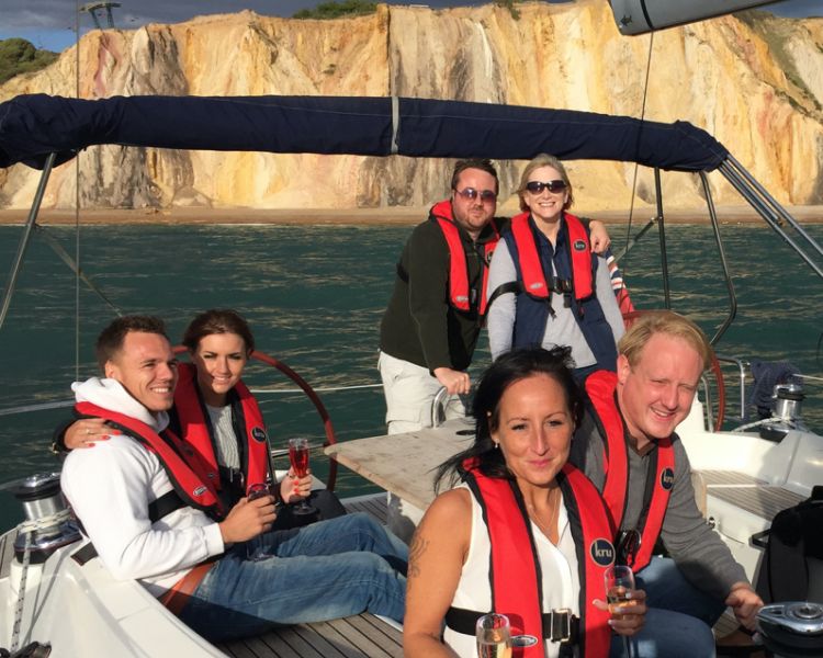 guests on yacht off alum bay on the solent