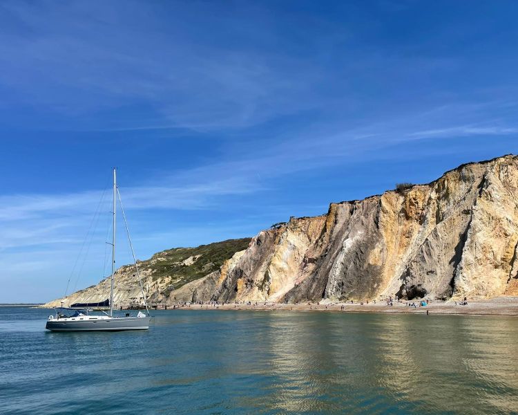 a yacht anchored off the coast of the isle of wight
