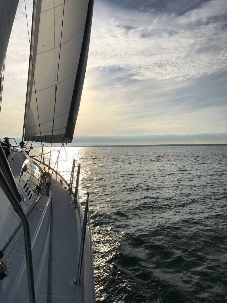 photo taken of side of a yacht in evening on solent