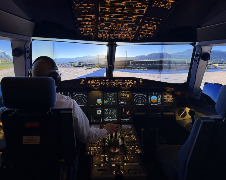 pilot in an aeroplane simulator looking out at airport