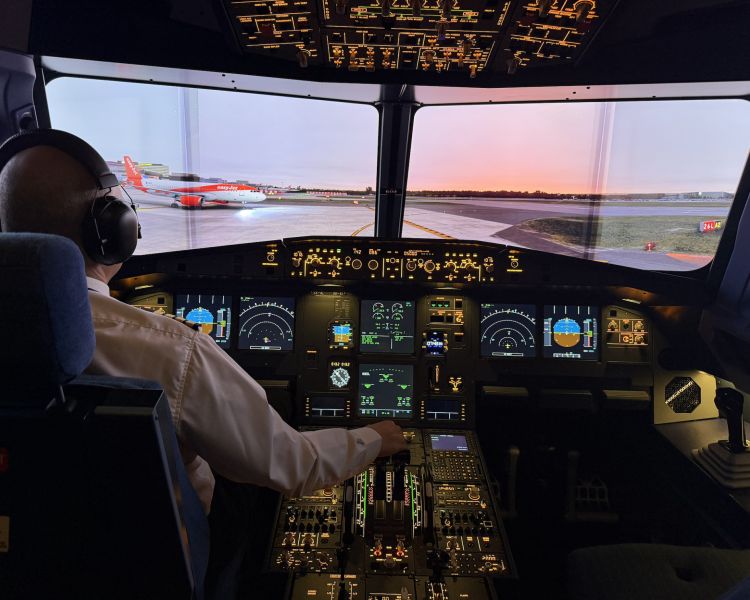 pilot in flight simulator looking out onto a runway
