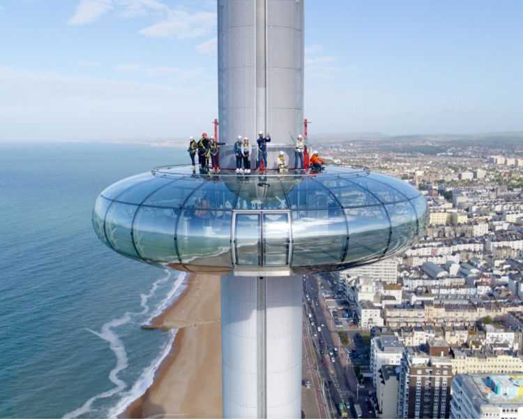 view of the i360 pod and people walking on top of it on a skywalk experience