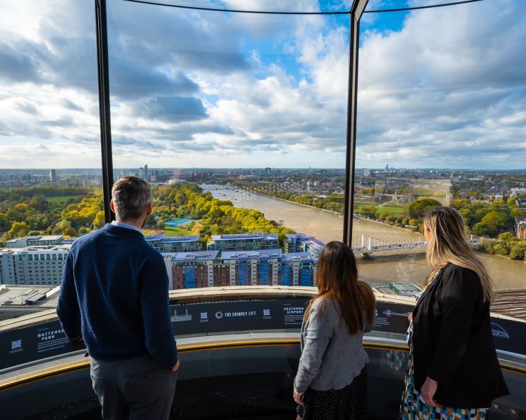 Family looking out at view over london from chimney lift