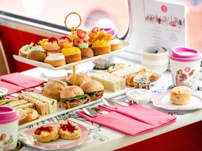 afternoon tea spread of cakes and sandwiches on an afternoon tea bus tour in london