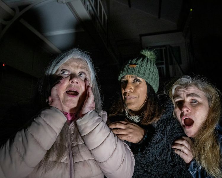three women looking scared on a ghost tour at a haunted prison experience day