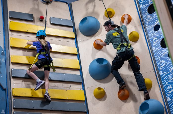 man and child on climbing wall at adventure climb experience in wales