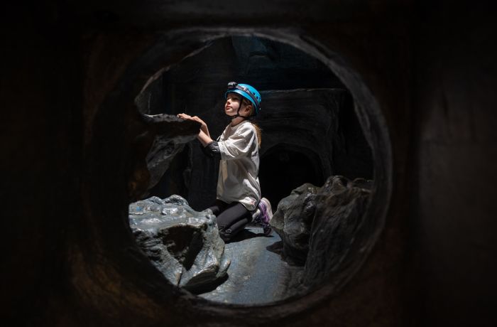 boy on indoor caving experience at activity centre in wales