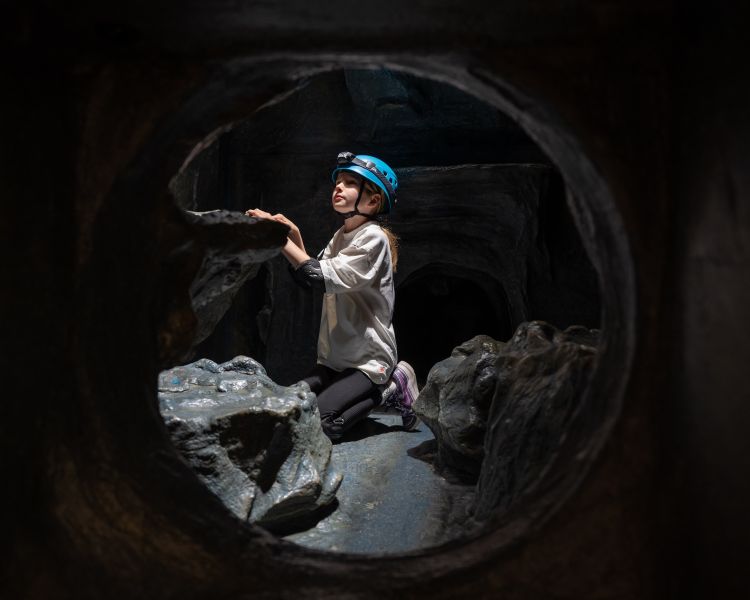 boy on indoor caving experience at activity centre in wales