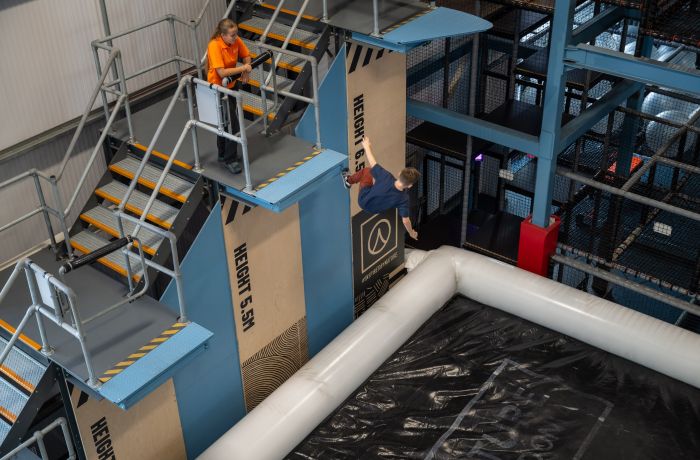 person jumping on adrenaline drop at activity centre in wales