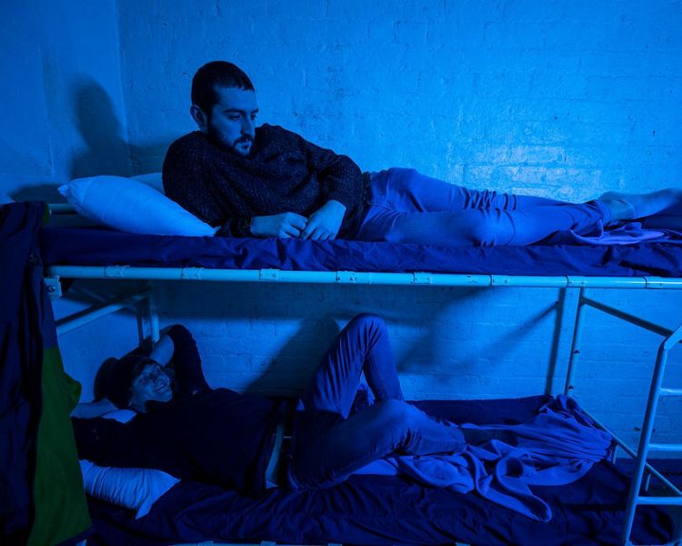 people on bunk beds in a prison cell as part of a prison break experience day
