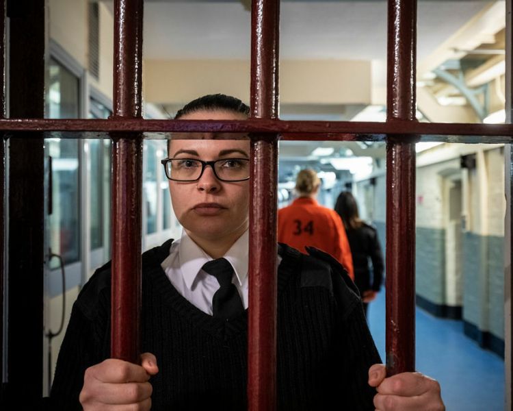 guard looking through bars as part of a prison break experience day