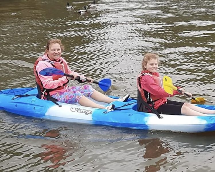 Woman and child kayaking at oulton broad water sports centre in suffolk