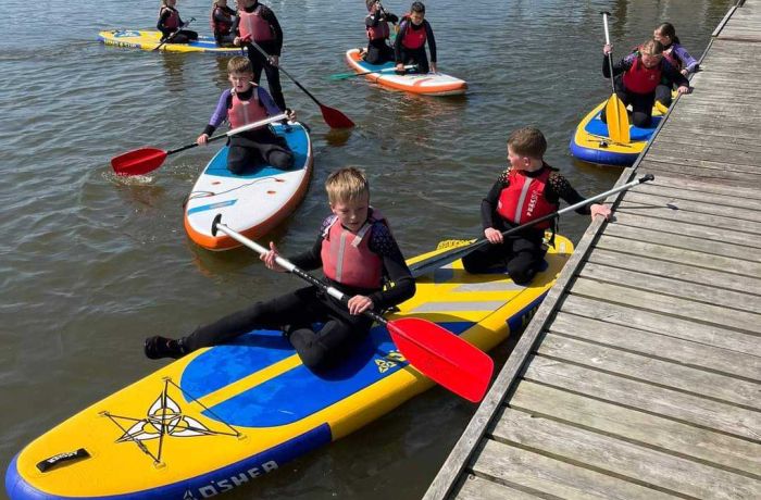 Children paddleboarding at oulton broad water sport centre