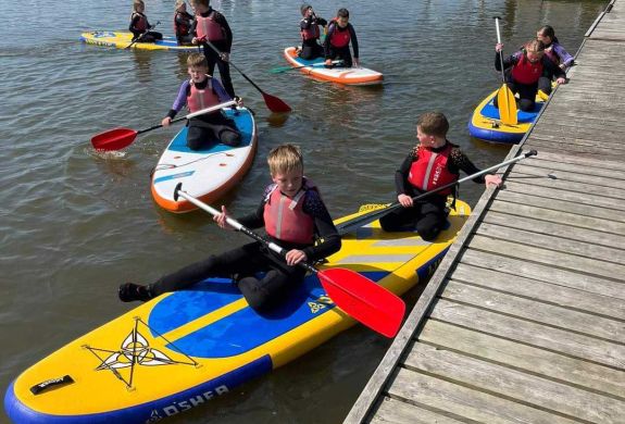 Children paddleboarding at oulton broad water sport centre