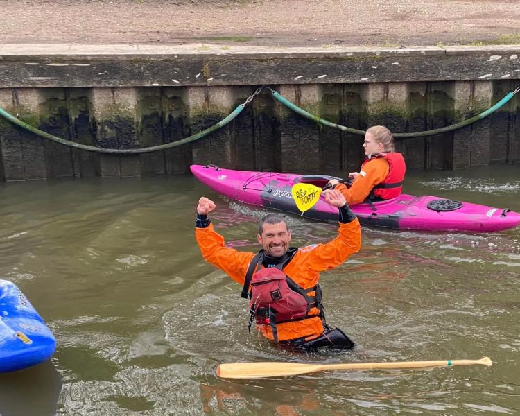 Man in water on kayak session at oulton broad water sports centre in suffolk