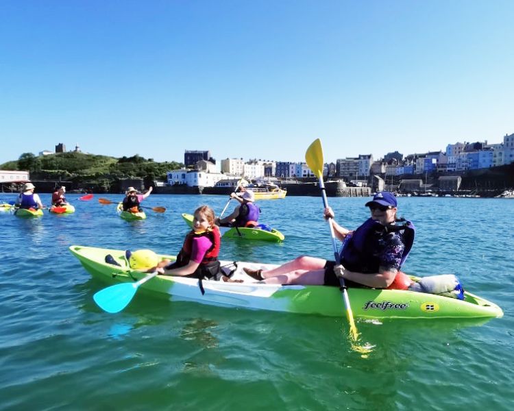 People in kayaks on water in pembrokeshire