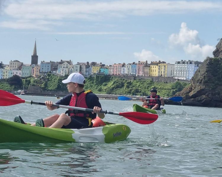 Kayakers on water on tenby coastline