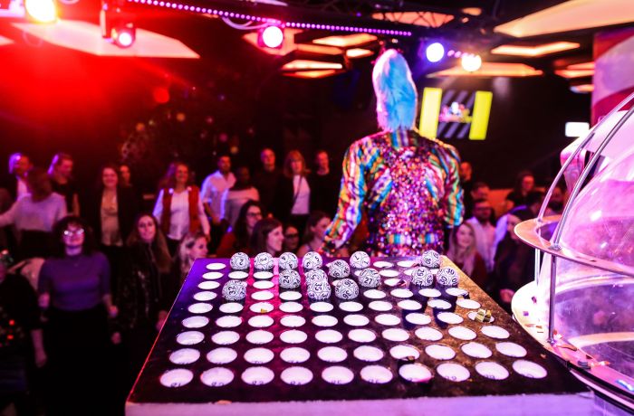 Bingo balls on stage showing crowds