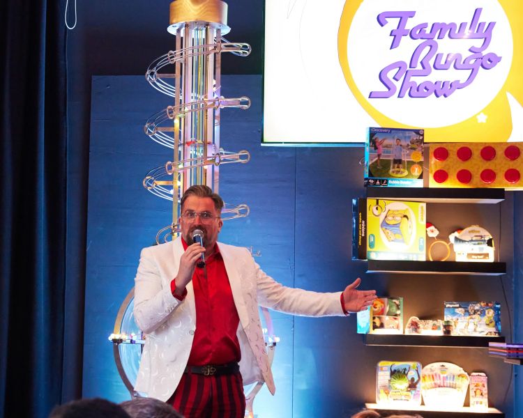 Host showing prizes at family bingo show in london