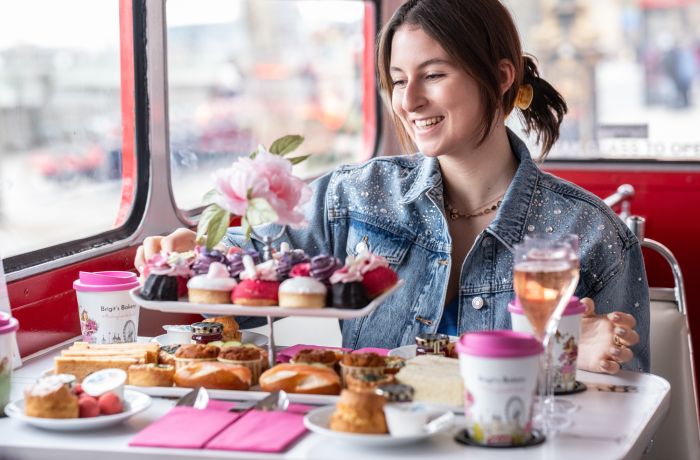 Woman eating afternoon tea on b bakery bus tour london