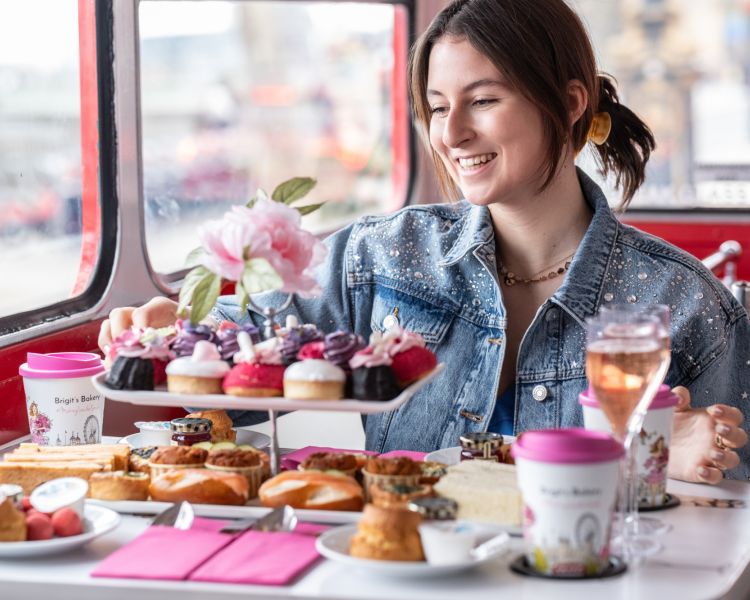 Woman eating afternoon tea on b bakery bus tour london