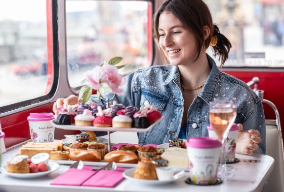 Woman eating afternoon tea on b bakery bus tour london