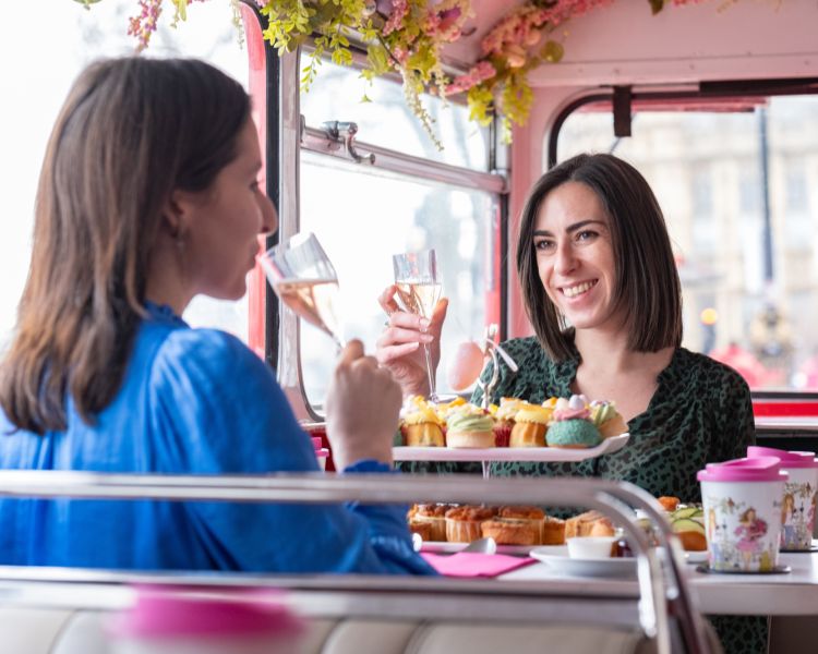 Ladies drinking prosecco on afternoon tea bus tour in london