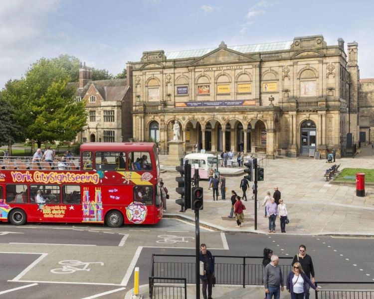 Sightseeing bus in york in front of art gallery