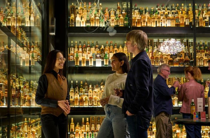 A guide and two guests at the edinburgh whisky tour