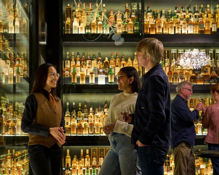 A guide and two guests at the edinburgh whisky tour