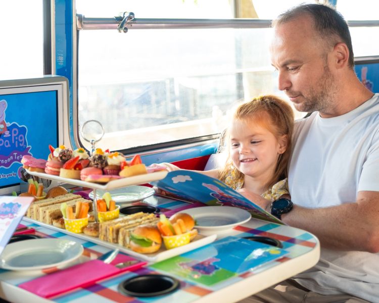 Dad and daughter on peppa pig afternoon tea bus tour