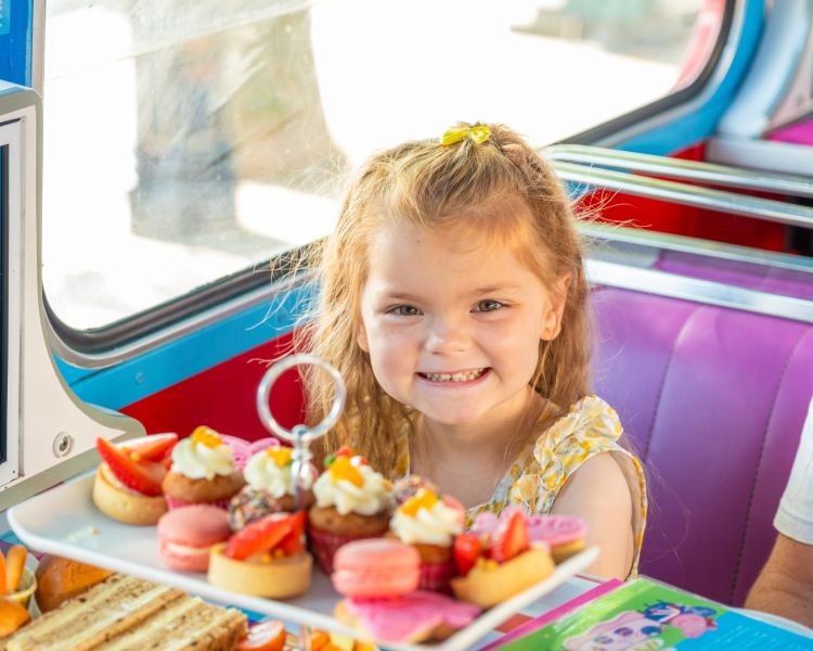 Little girl smiling on peppa pig afternoon tea bus tour