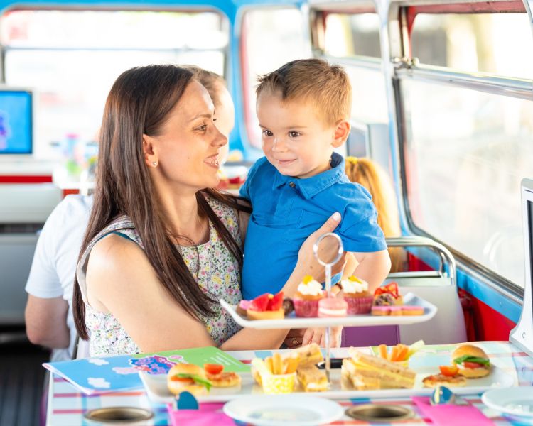 Mum and son on peppa pig afternoon tea bus tour